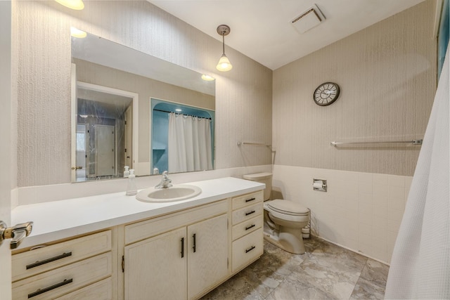 full bath featuring vanity, toilet, tile walls, curtained shower, and visible vents