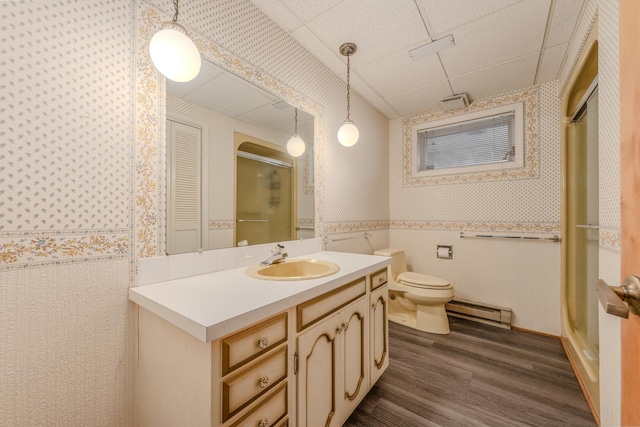 full bath featuring wallpapered walls, a shower stall, baseboard heating, and wood finished floors