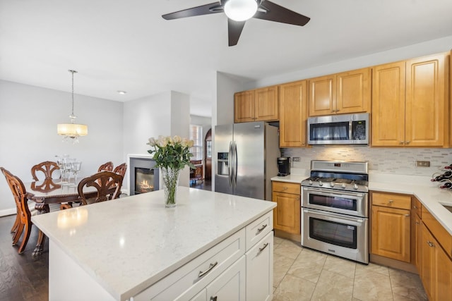 168 Willow Blvd, Willow Springs, IL 60480 - kitchen with stainless steel appliances, ceiling fan, tasteful backsplash, decorative light fixtures, and a kitchen island