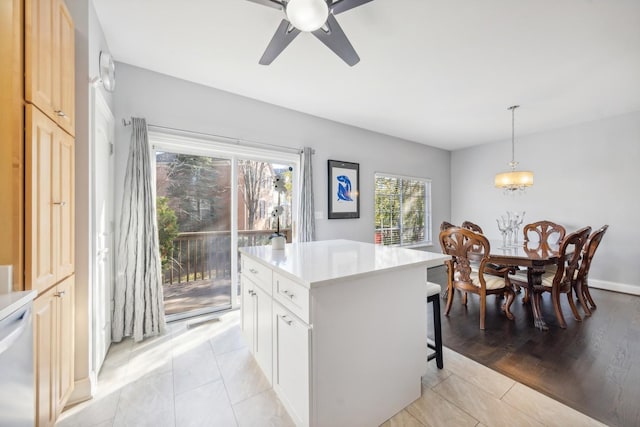 168 Willow Blvd, Willow Springs, IL 60480 - kitchen with a kitchen breakfast bar, light countertops, a ceiling fan, a center island, and pendant lighting
