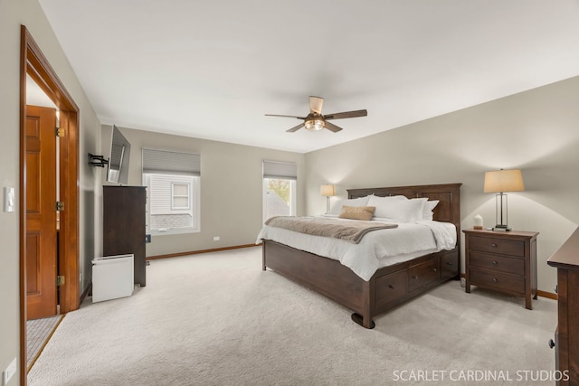 bedroom featuring baseboards, ceiling fan, and light colored carpet