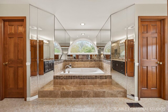 bathroom featuring vanity, visible vents, recessed lighting, tile patterned flooring, and a bath