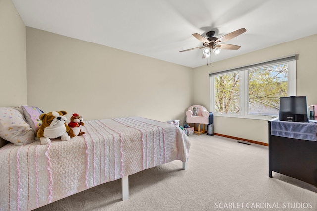 carpeted bedroom with baseboards, visible vents, and a ceiling fan