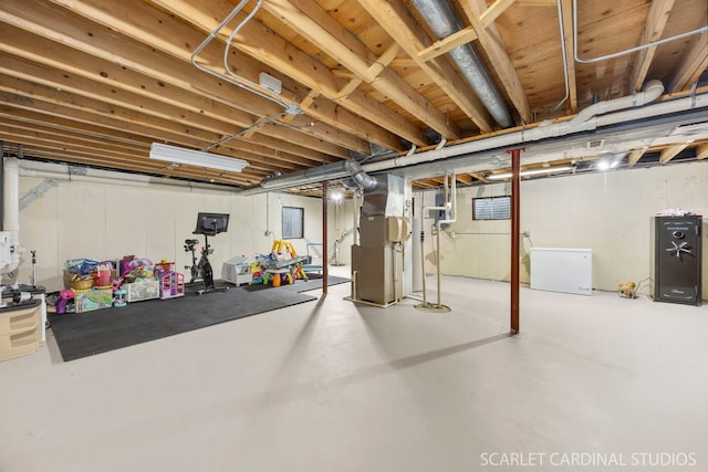 unfinished below grade area with fridge and heating unit