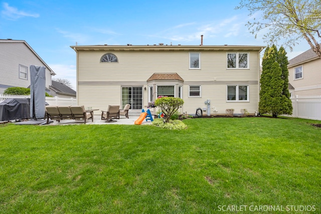 rear view of property featuring a lawn, a patio area, outdoor lounge area, and fence