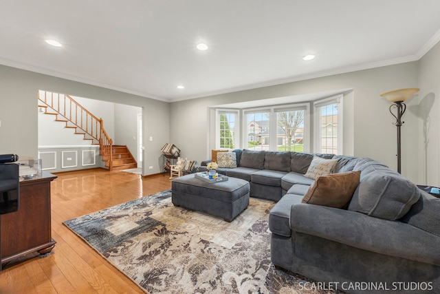 living area with ornamental molding, stairway, recessed lighting, and wood finished floors