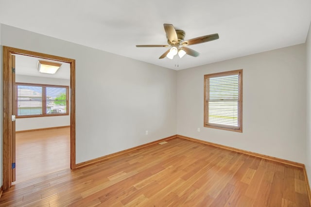 unfurnished room featuring baseboards, ceiling fan, and light wood-type flooring