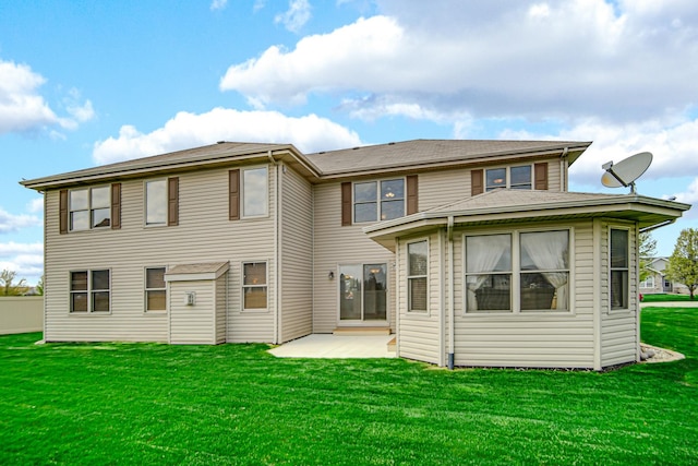 rear view of house with a patio and a yard