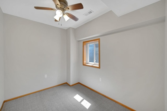 carpeted spare room with a ceiling fan, baseboards, and visible vents