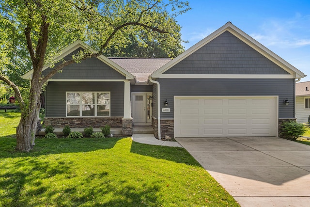 craftsman-style house featuring stone siding, an attached garage, a front yard, and concrete driveway