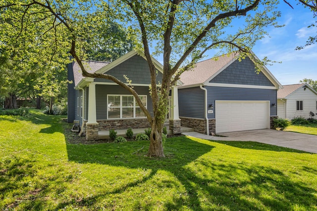 craftsman house featuring stone siding, a garage, concrete driveway, and a front yard