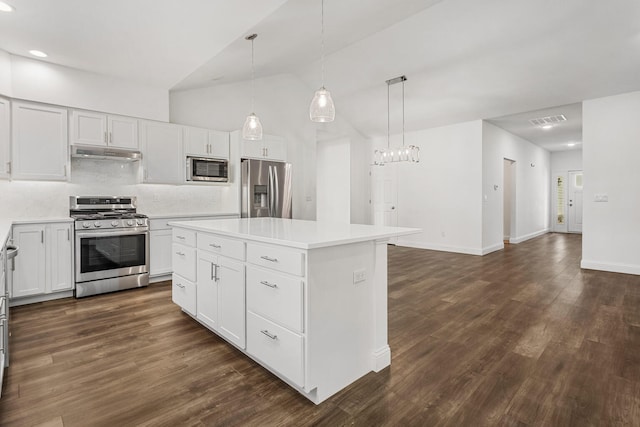 kitchen with stainless steel appliances, under cabinet range hood, a kitchen island, decorative backsplash, and light countertops