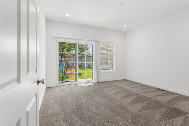 carpeted spare room featuring baseboards and recessed lighting