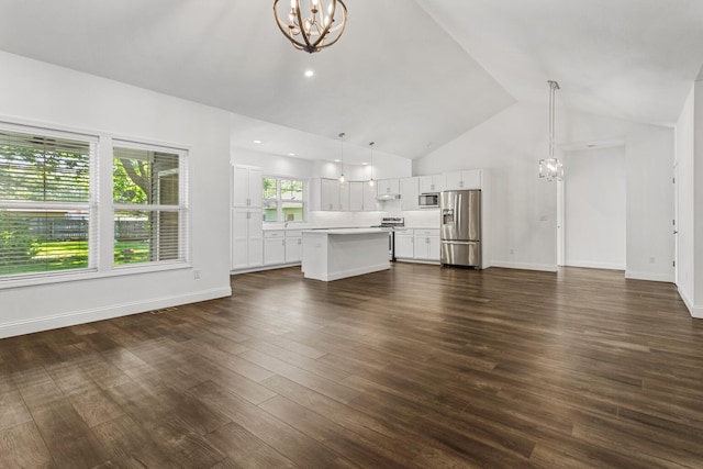 unfurnished living room featuring a chandelier, dark wood finished floors, baseboards, high vaulted ceiling, and recessed lighting