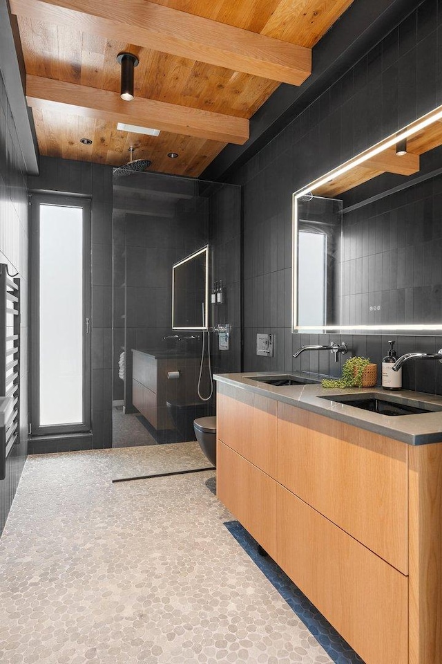full bath featuring toilet, tiled shower, double vanity, beam ceiling, and wood ceiling