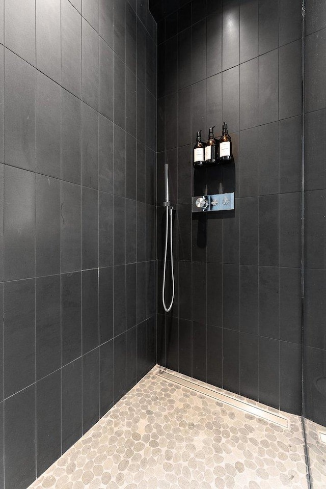 bathroom with tiled shower