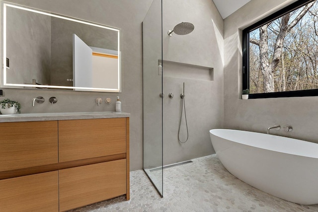 full bathroom with a walk in shower, double vanity, and a soaking tub
