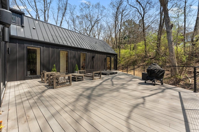 wooden deck with a grill