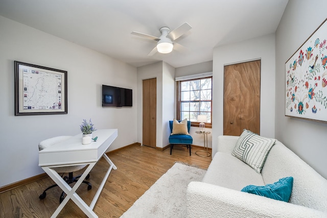 home office with baseboards, ceiling fan, and wood finished floors