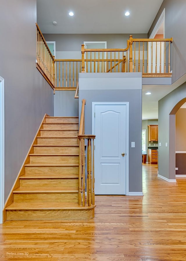 573 W Babcock Ave, Elmhurst, IL 60126 - staircase with wood finished floors, arched walkways, baseboards, and recessed lighting