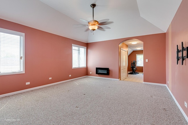 573 W Babcock Ave, Elmhurst, IL 60126 - unfurnished living room featuring ceiling fan, light colored carpet, arched walkways, lofted ceiling, and baseboards
