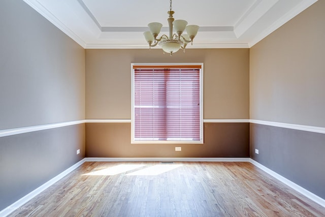 573 W Babcock Ave, Elmhurst, IL 60126 - empty room with a chandelier, a raised ceiling, wood finished floors, ornamental molding, and baseboards