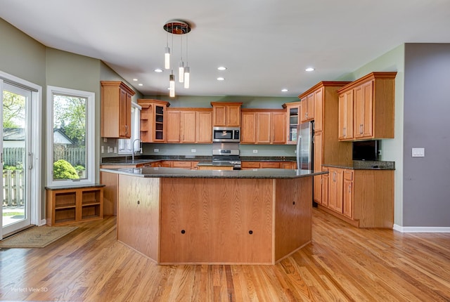 573 W Babcock Ave, Elmhurst, IL 60126 - kitchen featuring stainless steel appliances, light wood-type flooring, a kitchen island, glass insert cabinets, and recessed lighting