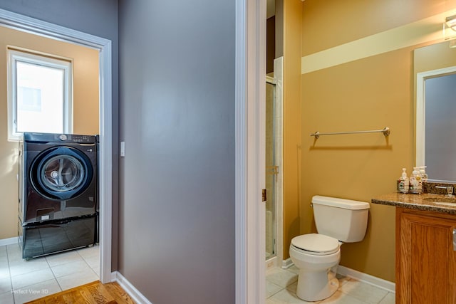 573 W Babcock Ave, Elmhurst, IL 60126 - bathroom with a stall shower, toilet, washer / clothes dryer, tile patterned floors, and baseboards