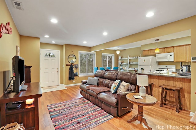 living room with light wood-style floors, recessed lighting, baseboards, and visible vents