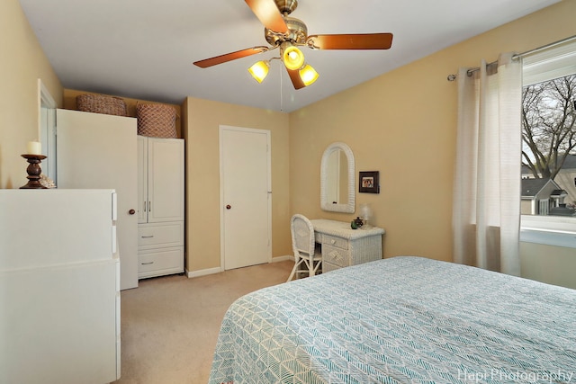 bedroom with baseboards, light carpet, and ceiling fan