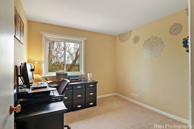 office space featuring baseboards and light carpet