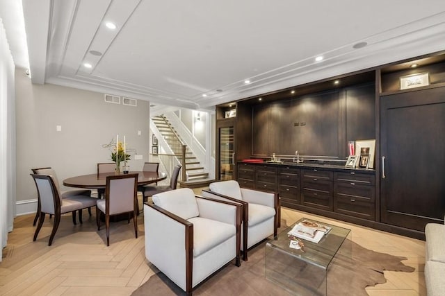 living room with recessed lighting, visible vents, beverage cooler, and stairway