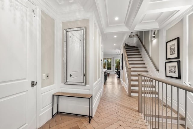 hall with a decorative wall, stairway, ornamental molding, coffered ceiling, and recessed lighting