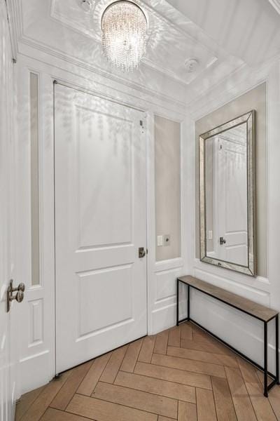 interior space with crown molding and a chandelier