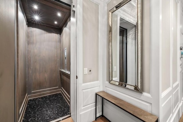 room details featuring a decorative wall and elevator