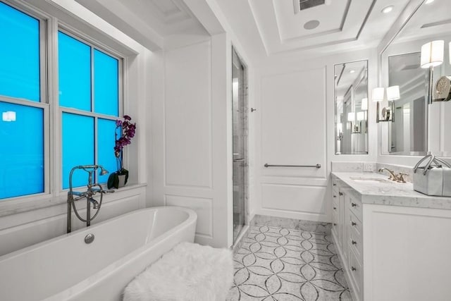 bathroom with visible vents, a shower stall, vanity, a soaking tub, and recessed lighting
