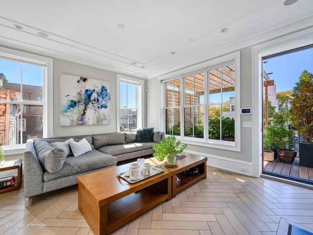 sunroom with visible vents and a healthy amount of sunlight