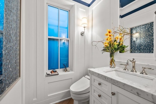 half bath featuring toilet and vanity