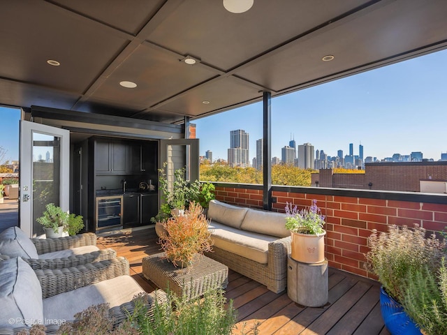 deck with an outdoor living space, a city view, and wine cooler