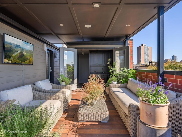 balcony with a sink and an outdoor hangout area