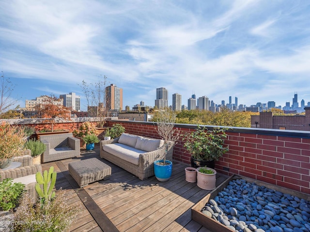 deck with a view of city and outdoor lounge area