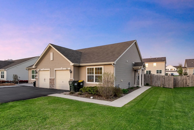 733 Florence St, Hampshire, IL 60140 - view of front of home featuring aphalt driveway, fence, a front yard, a shingled roof, and an attached garage