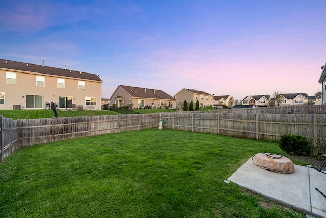 733 Florence St, Hampshire, IL 60140 - yard at dusk with a fenced backyard, a patio, and a residential view