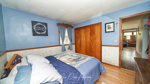 23233 W N Lakewood Ln, Lake Zurich, IL 60047 - bedroom featuring a closet, wood finished floors, and a wainscoted wall