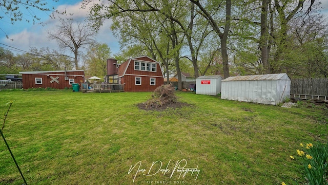 23233 W N Lakewood Ln, Lake Zurich, IL 60047 - view of yard featuring a wooden deck, fence, an outbuilding, and a storage unit