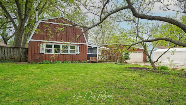 23233 W N Lakewood Ln, Lake Zurich, IL 60047 - exterior space with fence, board and batten siding, a sunroom, and a front lawn