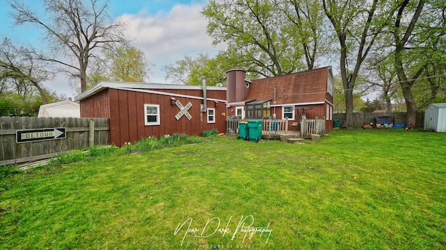 23233 W N Lakewood Ln, Lake Zurich, IL 60047 - rear view of property featuring a lawn, fence, an outbuilding, and a storage shed