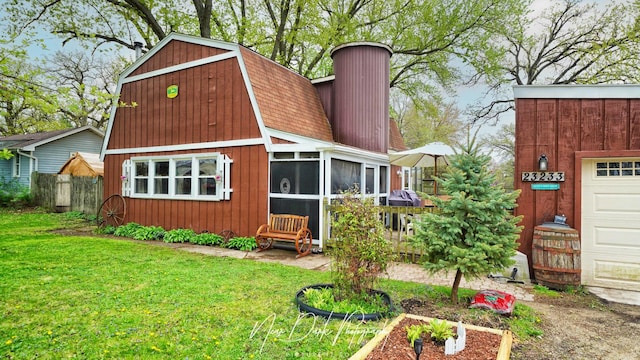 23233 W N Lakewood Ln, Lake Zurich, IL 60047 - back of house featuring a yard, fence, a chimney, and a gambrel roof