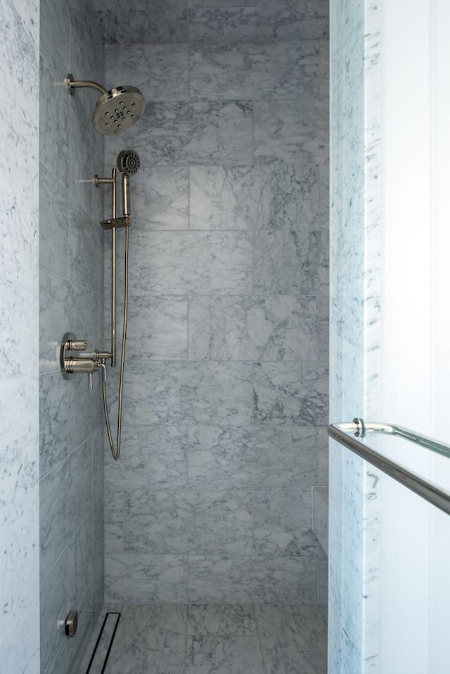 full bath with a tile shower
