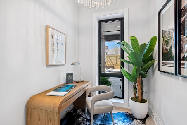 interior space with baseboards and a chandelier